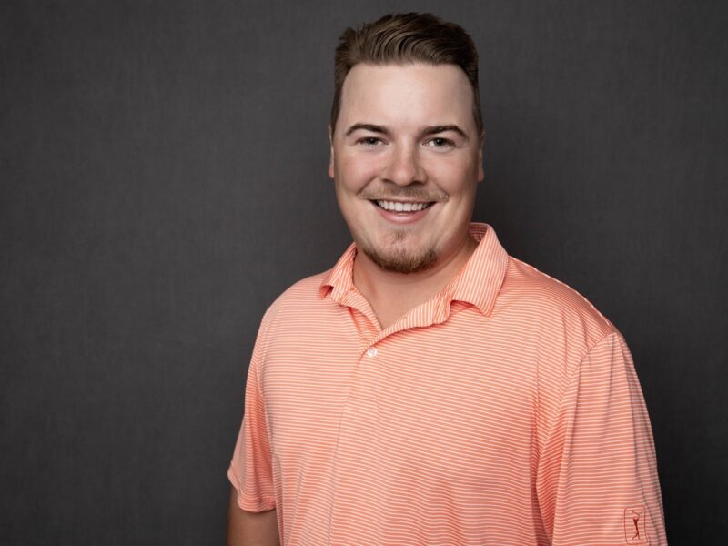 professional portrait of Scott Ellis smiling in an orange polo