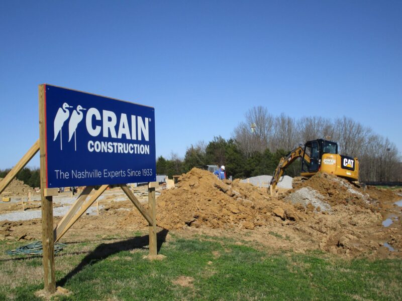 Crain Sign in front of a pile of dirt at a construction site