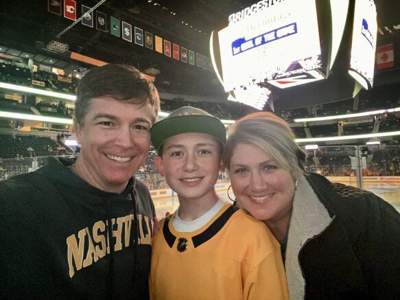 Mark Rankin's wife and son smiling at a predators game.