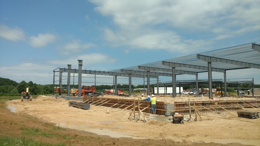 Subcontractors putting up the steel framing for a future food bank.