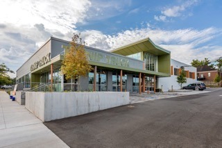Street view of an architecturally modern grocery store called the Turnip Truck