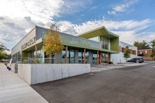 Street view of an architecturally modern grocery store called the Turnip Truck