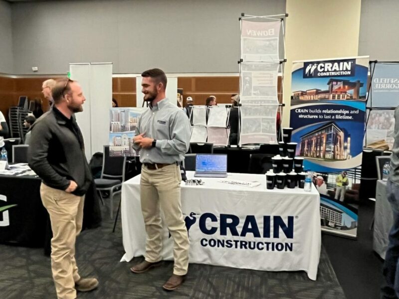 Spencer Rankin is standing in front of the Crain Construction booth at the MTSU Career Fair