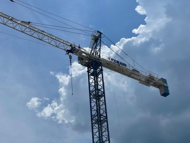 Crain Construction logo on a Crain raised high in the clouds