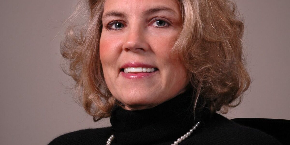 Portrait of Sherry Arledge, wearing professional attire, with a friendly smile, in a well-lit indoor setting.