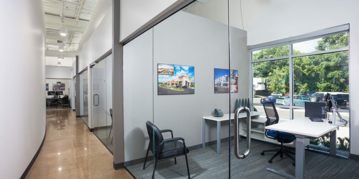 Inside of the Crain Construction Office, featuring all-glass doors and exposed ceilings.