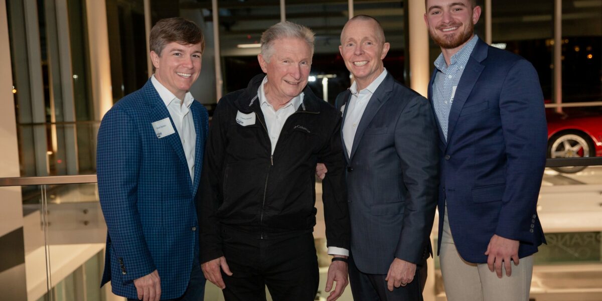 Crain Construction Leadership posing for a photo in suits