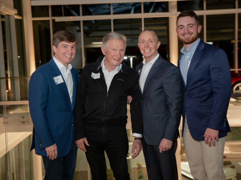 Crain Construction Leadership posing for a photo in suits